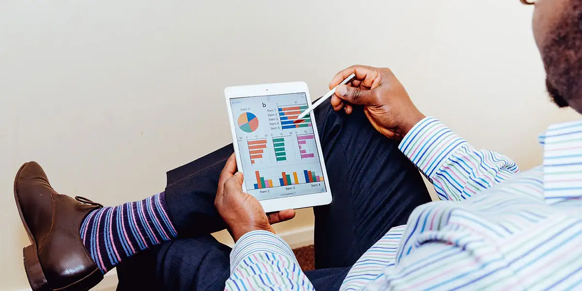 Best eCommerce Tools – business professional reviewing ecommerce analytics on a tablet