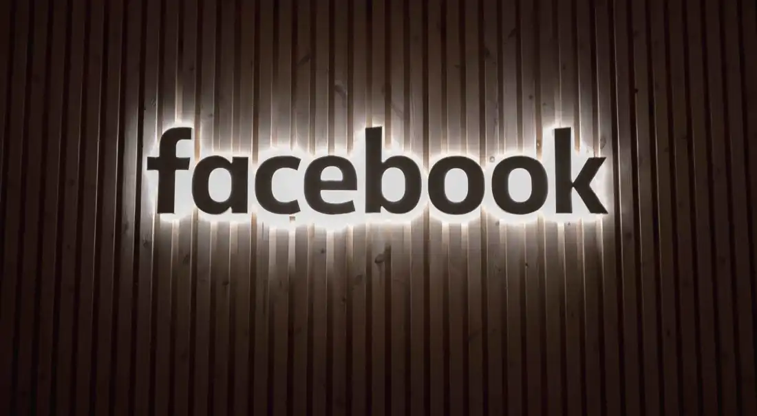 Facebook Marketplace – illuminated Facebook logo displayed on a wall