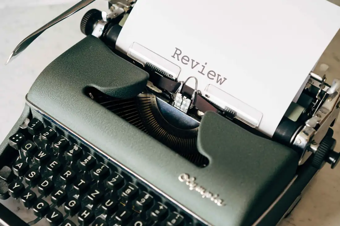 Etsy reviews – vintage typewriter with the word “review” typed on paper