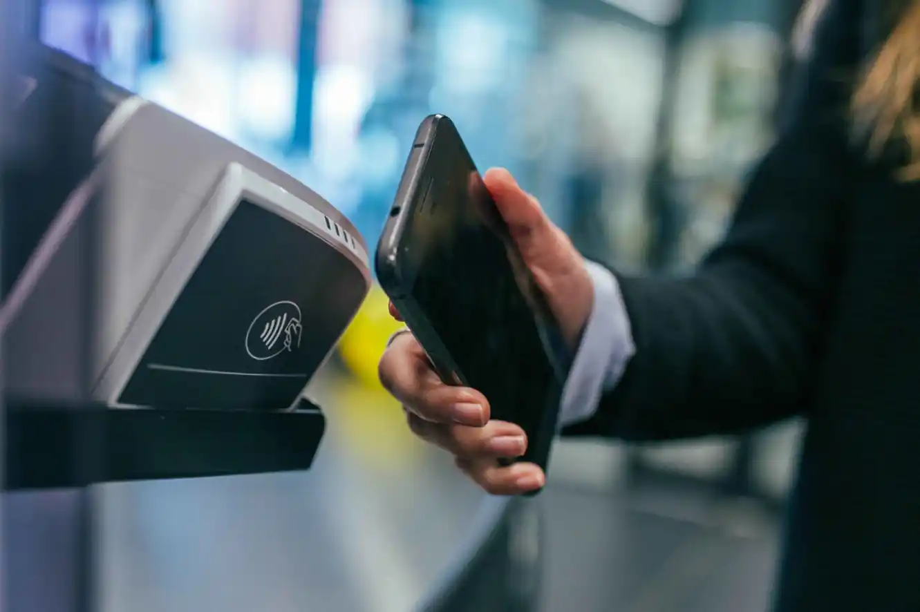 WIX payments gateway payment with a smartphone at a wireless payment terminal.