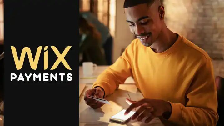 Wix Payments banner showing a man using his phone and credit card to make an online payment.