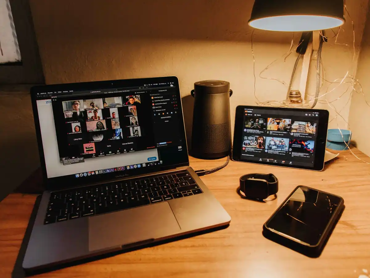 CRM marketing workspace showing laptop, tablet, and smart devices on a modern desk setup
