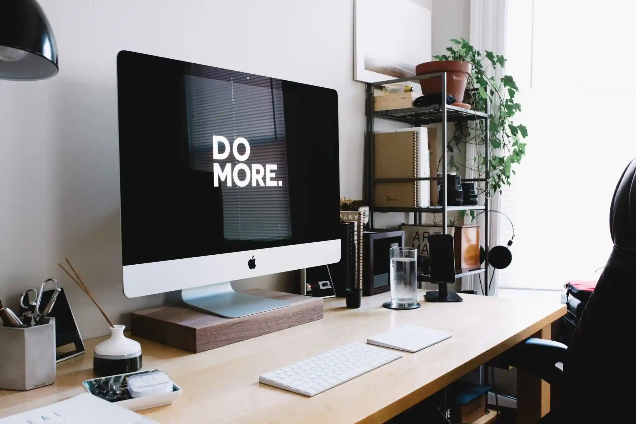 Modern workspace with an iMac displaying “DO MORE.” on screen, representing premium Squarespace templates for professional website design
