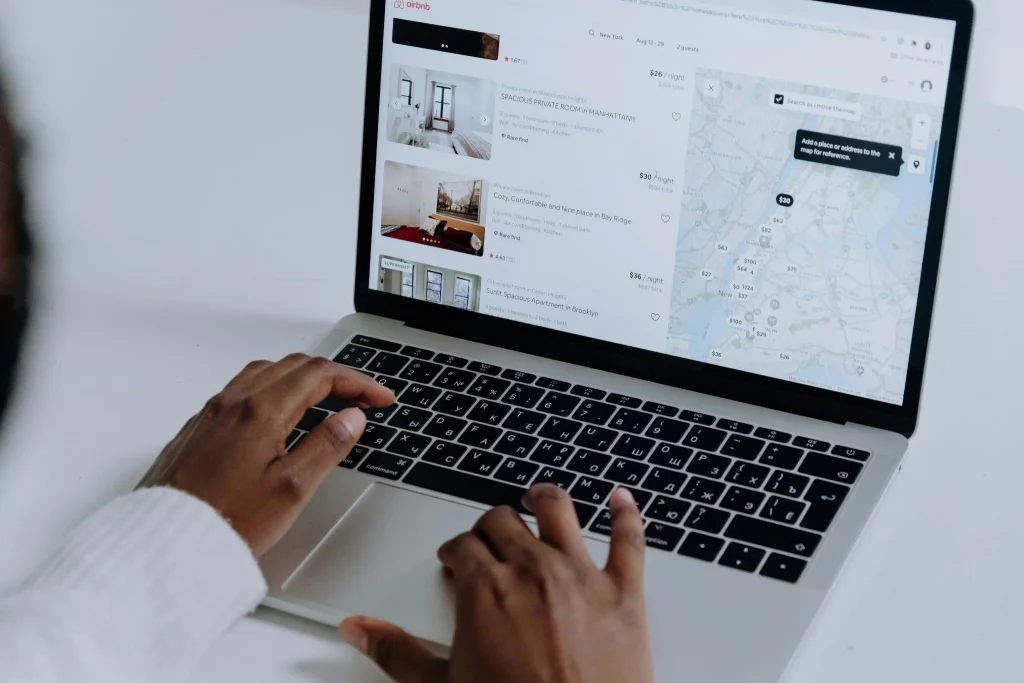 Hands typing on laptop showing a map listing, citations for local SEO